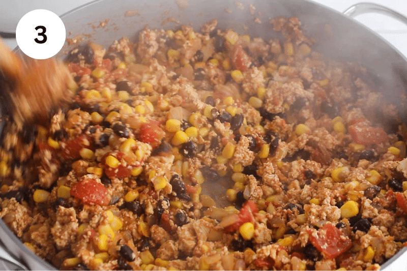 A large pan cooking a tofu-bean mix.