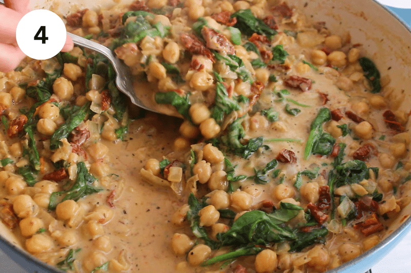 A large pan with a saucy chickpea mix.