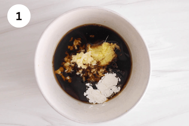 A bowl with the ingredients needed to make ginger sesame garlic sauce.