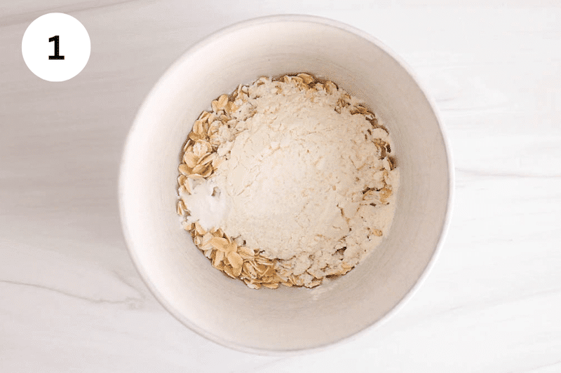 Oats and flour to a bowl.