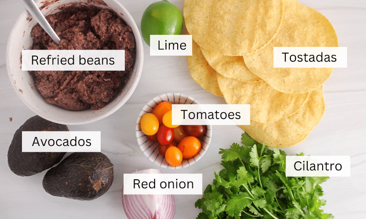 Showing are the ingredient to make avocado tostadas.