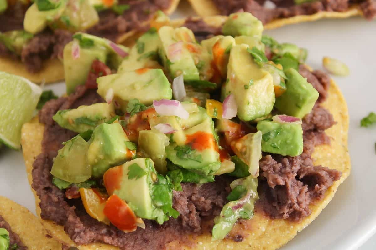 Avocado salad over a black bean tostadas.