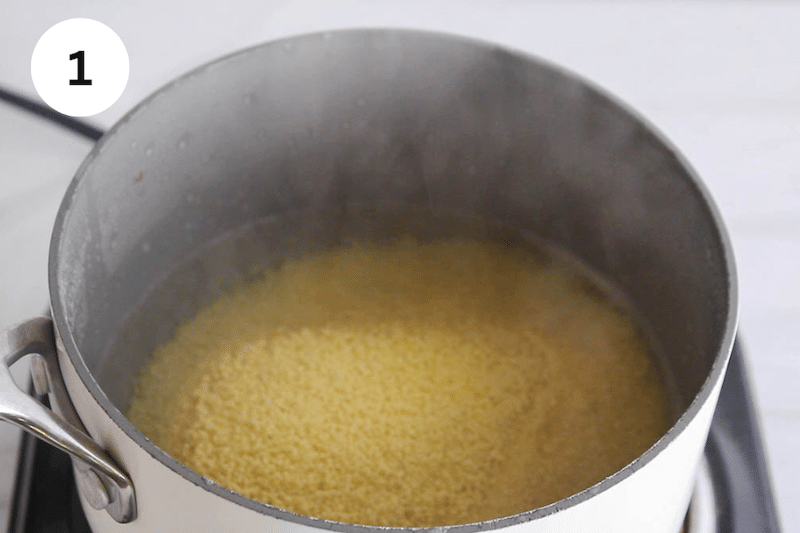 A small pot with couscous and boiling water.