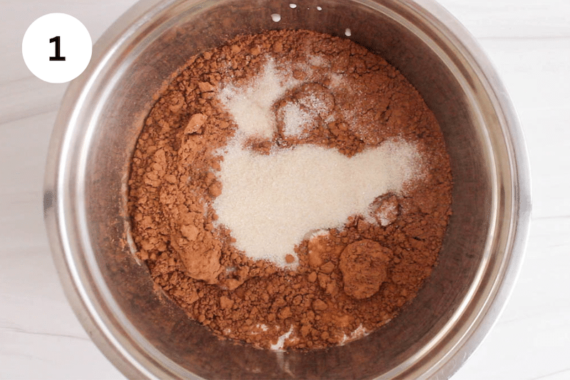 A bowl with cacao powder and sugar over coconut milk.