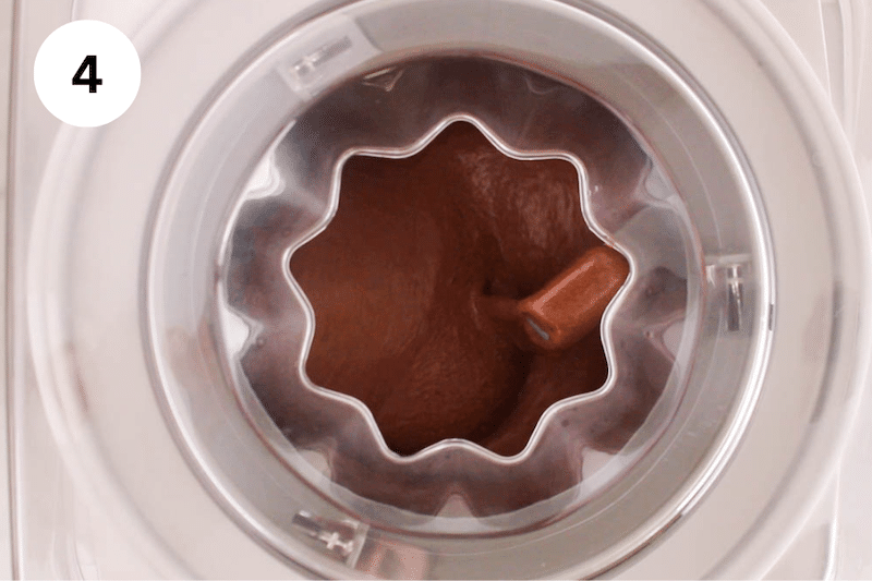 An ice cream machine filled with vegan chocolate ice cream.