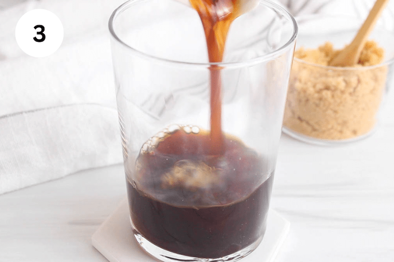 Espresso coffee pouring in a large glass.