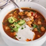 A spoon in a bowl of Mexican Chickpea soup.